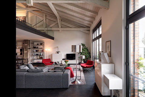 main level livingroom with grey sofas, windows to the right