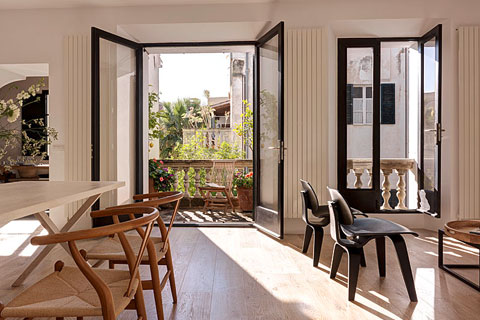 living room chairs and table, black framed balcony windows