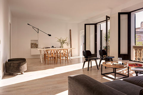 bright living room blond wooden floor table with chairs in the background