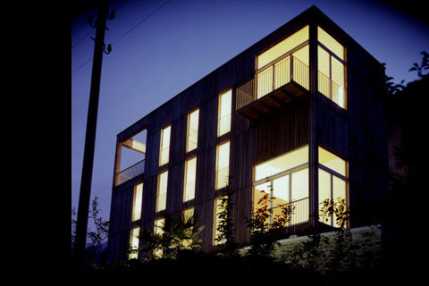 house at night, lighted windows