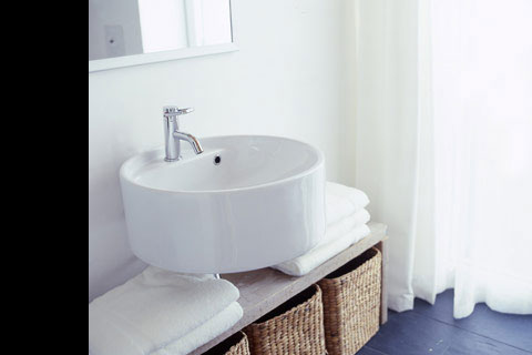 bathroom and round white washbasin