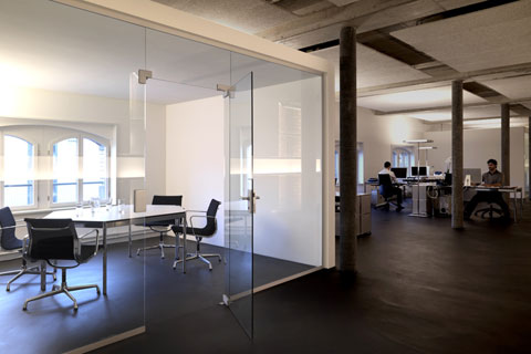 conference room separated by a glass front table and chairs behind